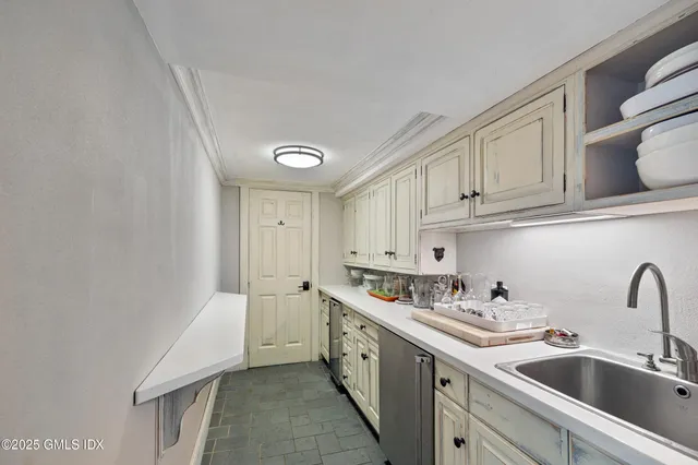 a kitchen with stainless steel appliances granite countertop a sink and cabinets
