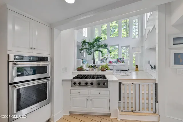 a kitchen with appliances a sink and a cabinets