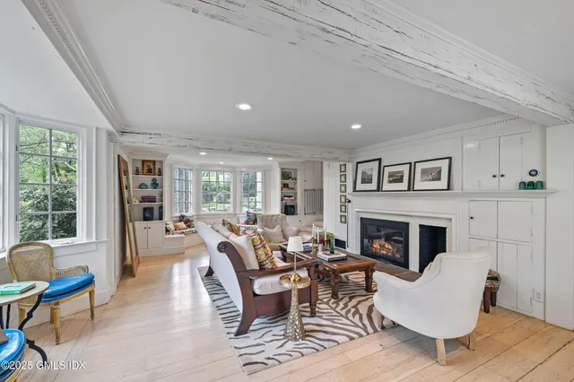 a living room with furniture fireplace and window