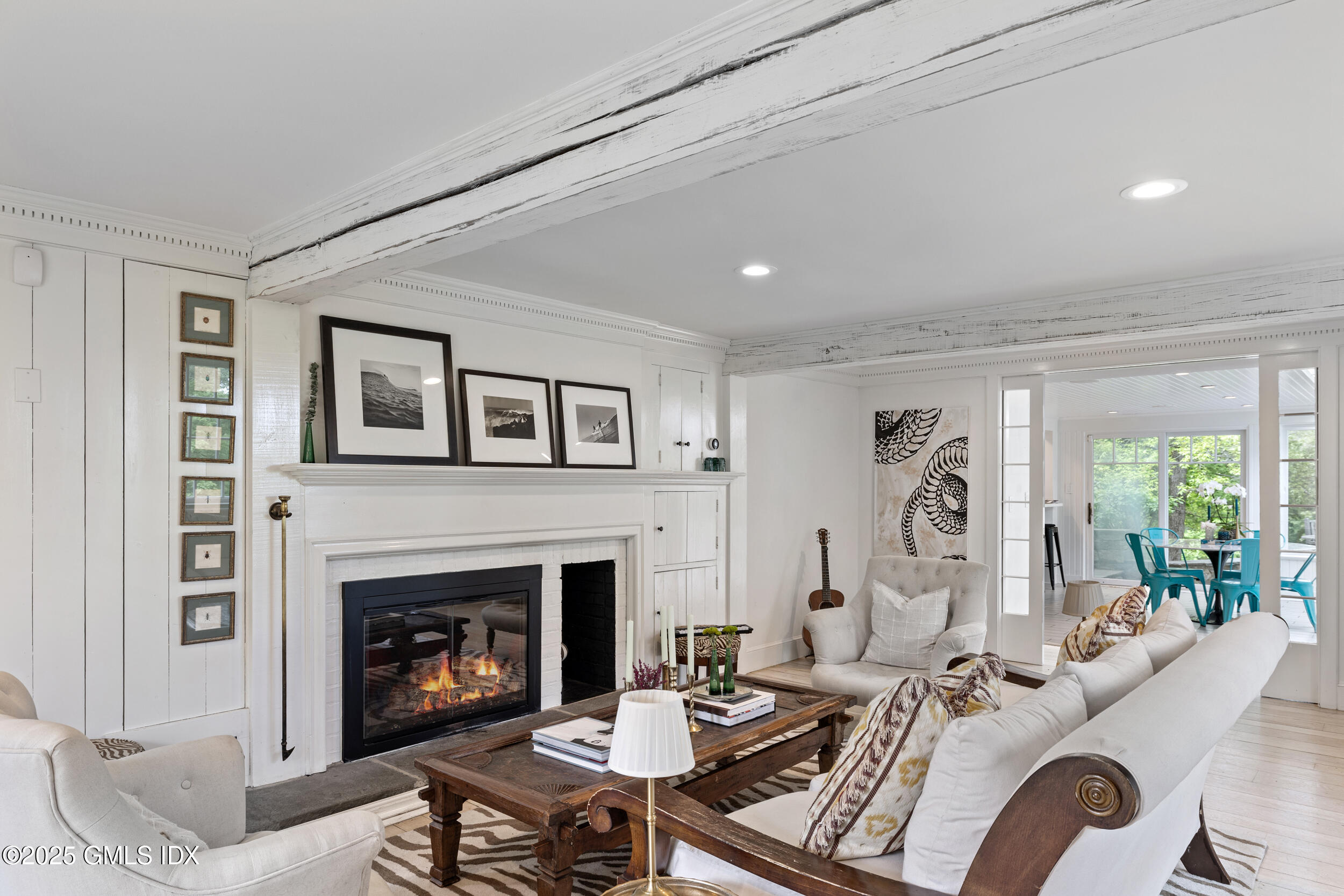 467 Laurel Road New Canaan, CT 06840 - Photo 31 of 50 a living room with furniture fireplace and a table