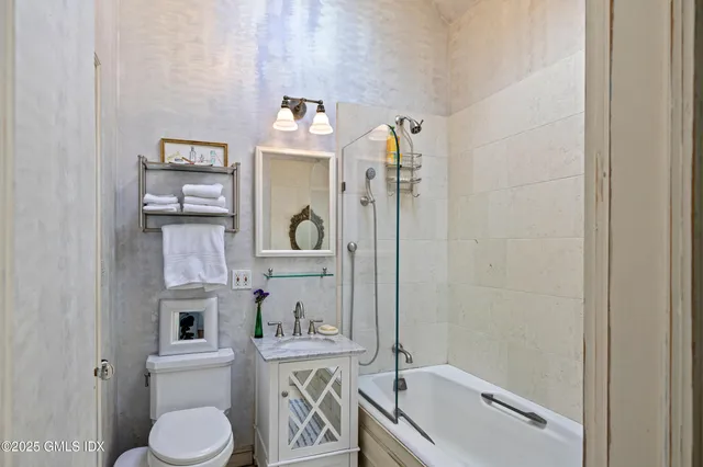 a bathroom with a tub sink and toilet