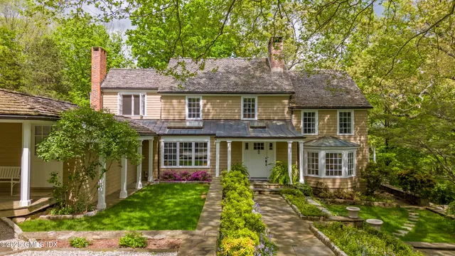 a front view of a house with a garden