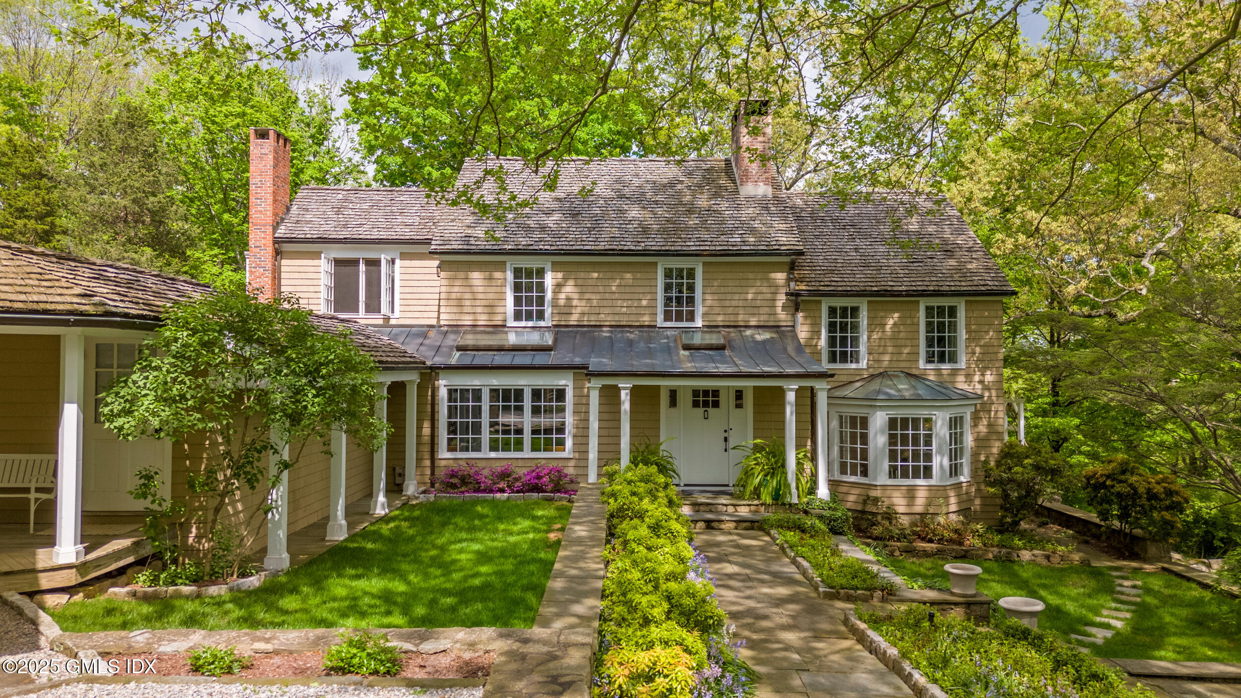 467 Laurel Road New Canaan, CT 06840 - Photo 4 of 50 a front view of a house with a garden