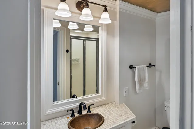 a bathroom with a sink vanity and a mirror