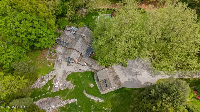 an aerial view of a house with a yard