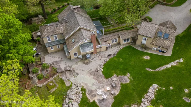an aerial view of a house with garden space and street view