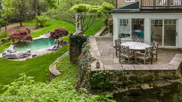 a view of a house with backyard porch and sitting area