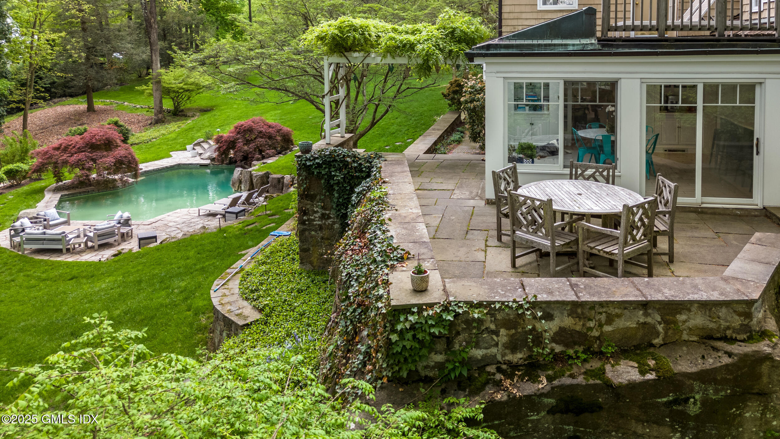 467 Laurel Road New Canaan, CT 06840 - Photo 9 of 50 a view of a house with backyard porch and sitting area
