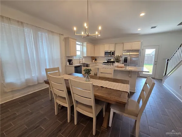 a dining room with furniture and wooden floor