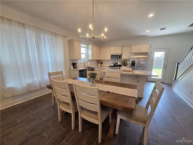 a dining room with furniture and wooden floor