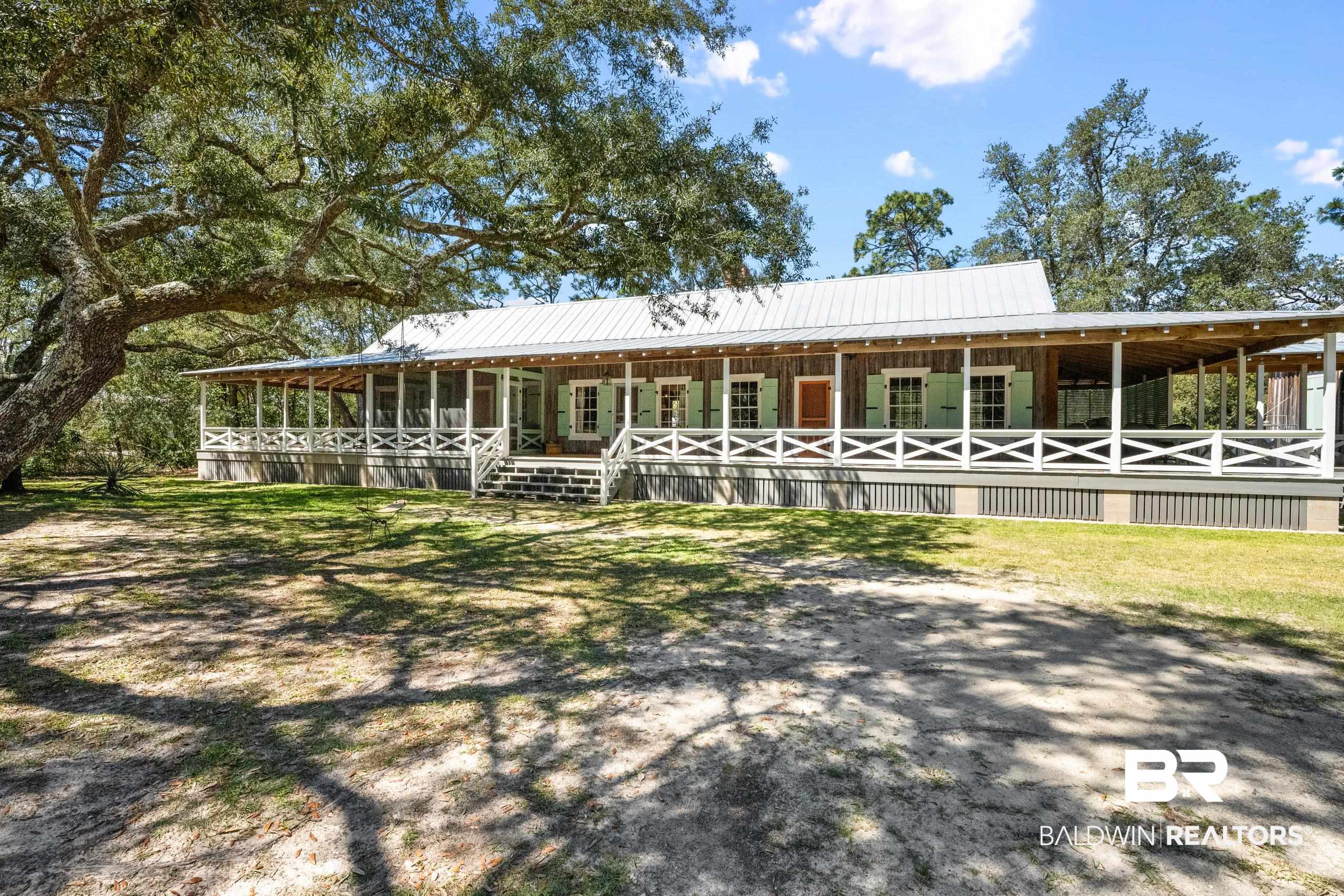 30671 Magnolia Street Elberta, AL 36530 - Photo 4 of 68 Farmhouse inspired home featuring an exterior structure, metal roof, and an outbuilding