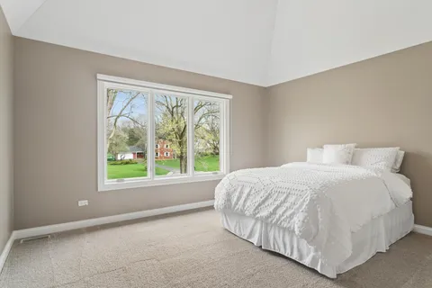 a bed sitting in a bedroom next to a window