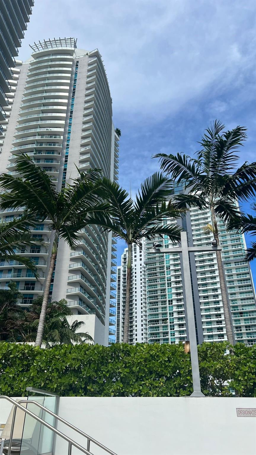 a view of a white building next to a yard
