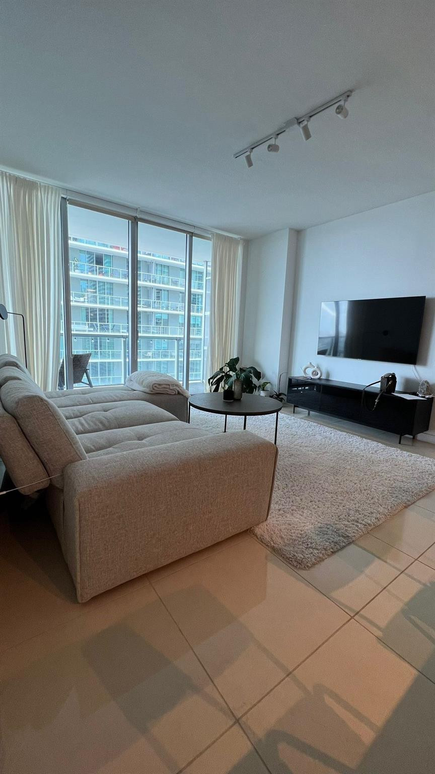 79 Southwest 12th Street, Unit 2908S Miami, FL 33130 - Photo 13 of 29 a bedroom with a bed and a flat screen tv