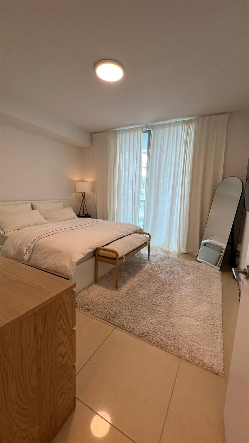 79 Southwest 12th Street, Unit 2908S Miami, FL 33130 - Photo 15 of 29 a bedroom with a bed and chair