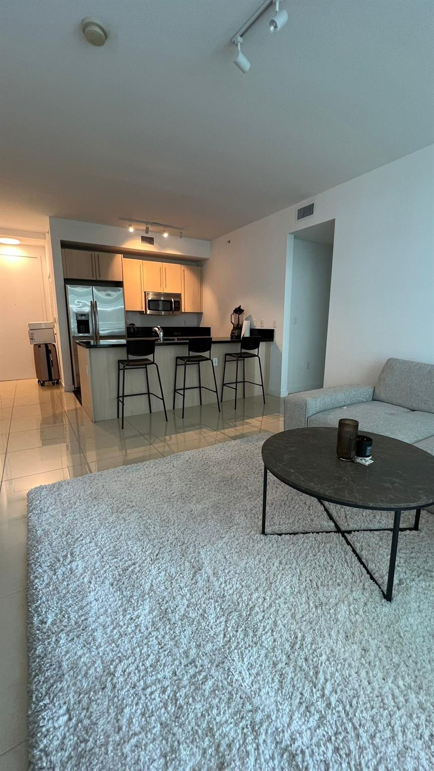 79 Southwest 12th Street, Unit 2908S Miami, FL 33130 - Photo 17 of 29 a living room with furniture a rug and a table
