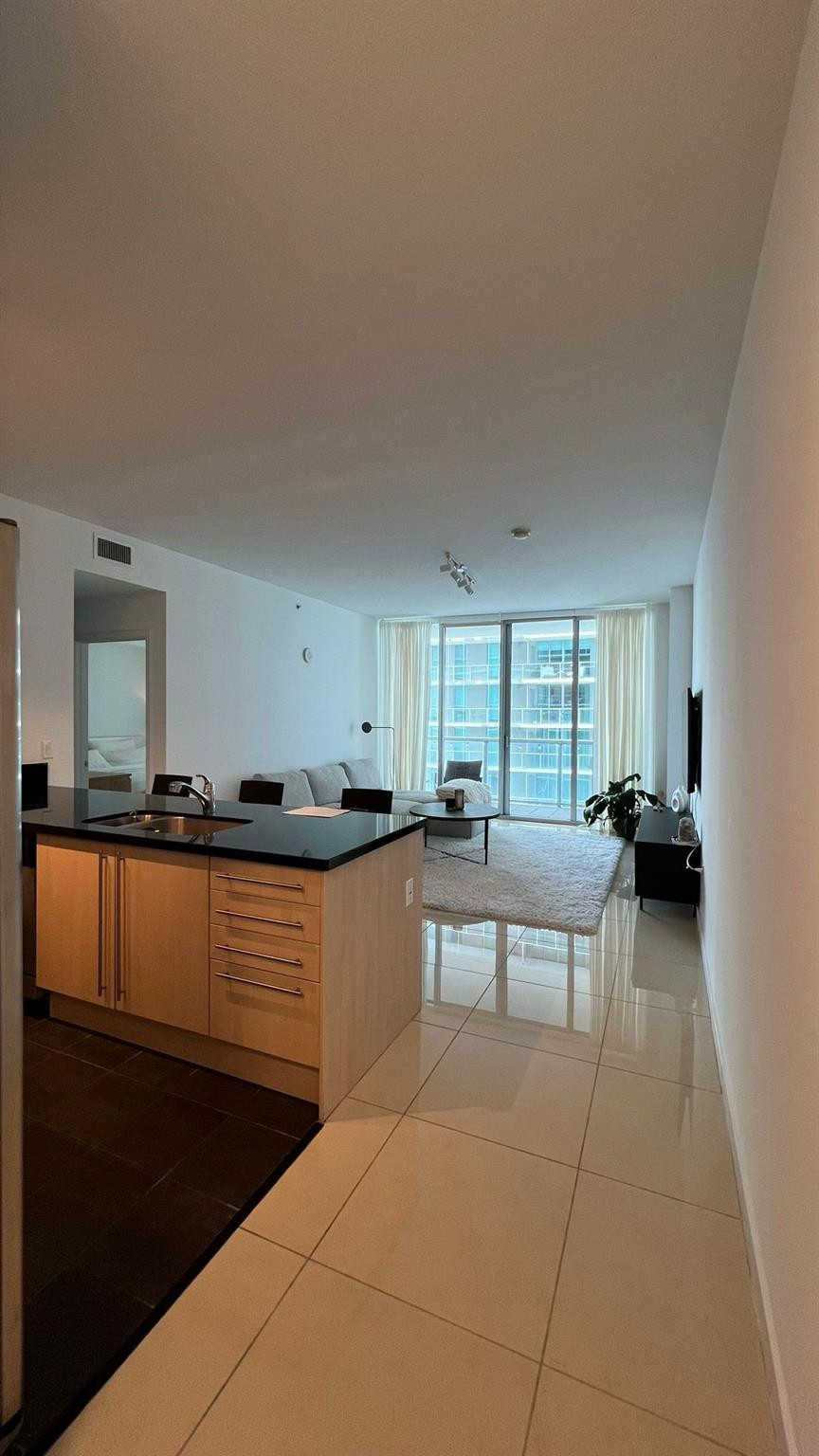 79 Southwest 12th Street, Unit 2908S Miami, FL 33130 - Photo 20 of 29 a kitchen with stainless steel appliances kitchen island granite countertop a sink and cabinets