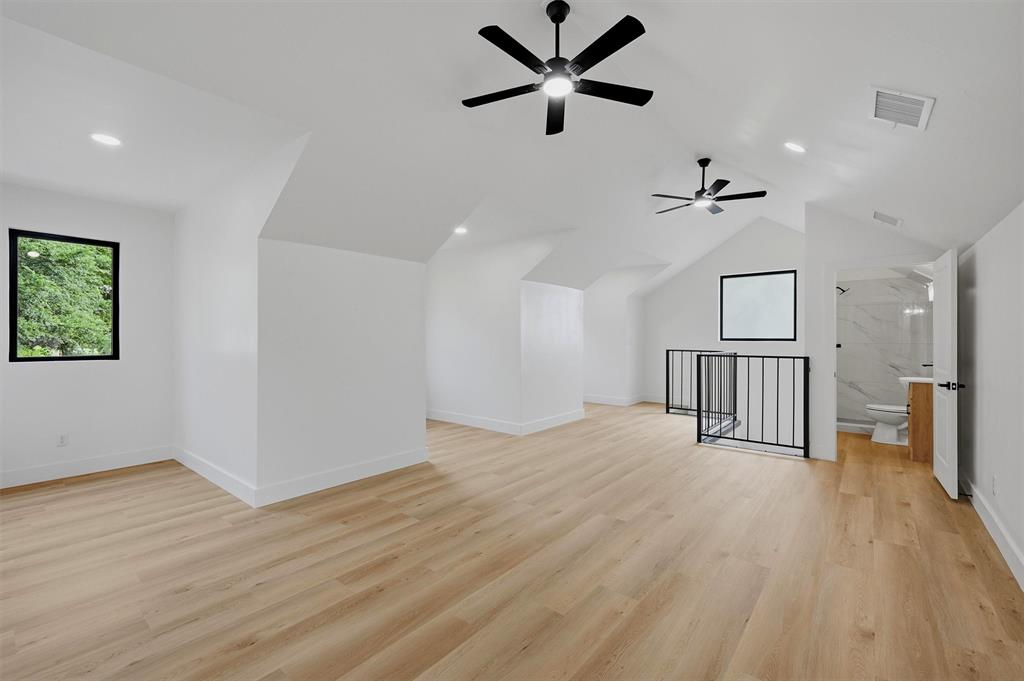 410 Arkansas Road Sadler, TX 76264 - Photo 28 of 40 Spacious loft area featuring light wood-finish flooring, vaulted ceilings, and recessed lighting