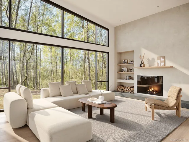 a living room with furniture fireplace and a large window