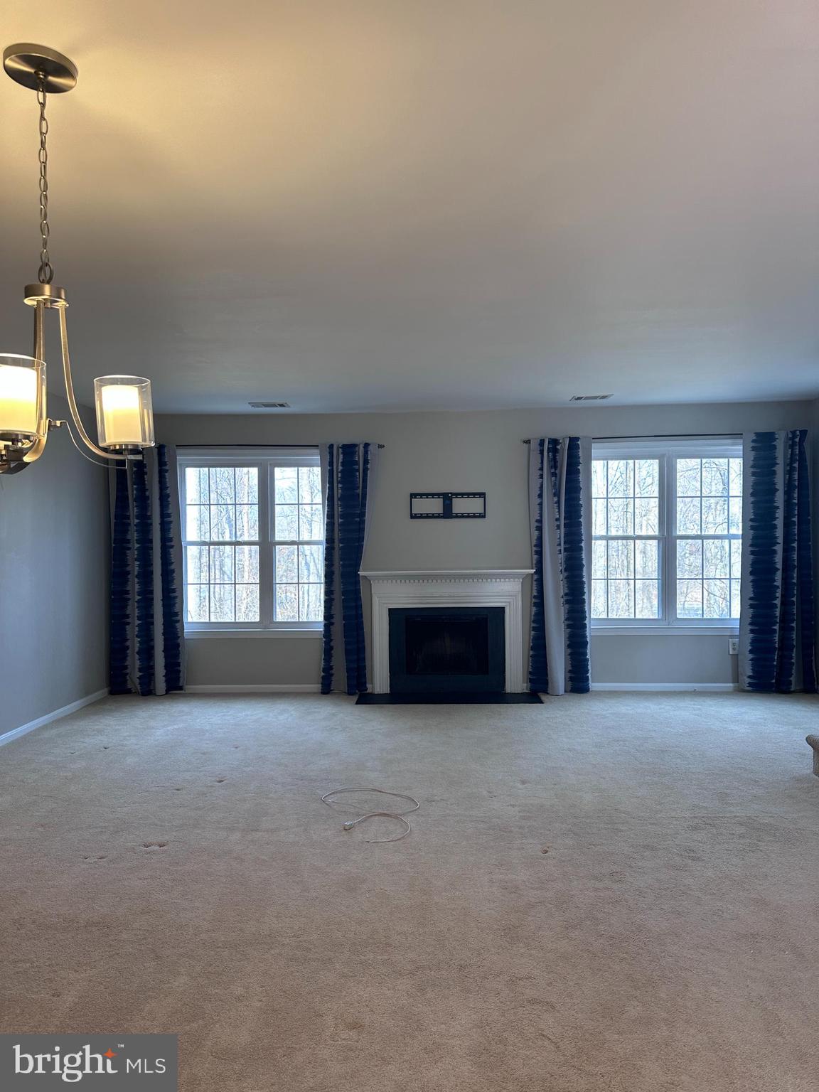 5832 1st Landing Way, Unit 137 Burke, VA 22015 - Photo 12 of 30 a view of an empty room with a fireplace and a window