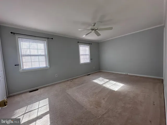 a view of empty room with windows