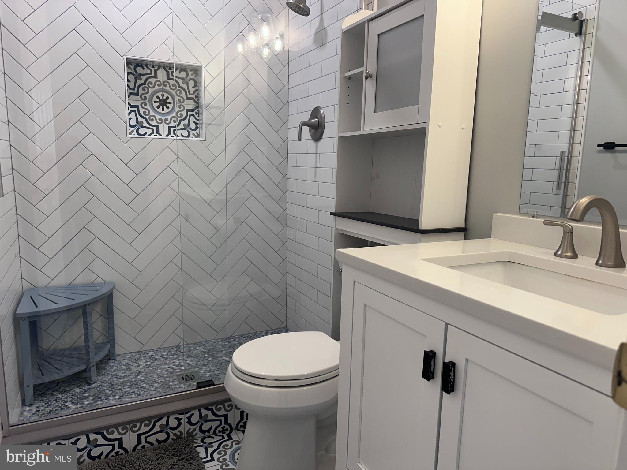 5832 1st Landing Way, Unit 137 Burke, VA 22015 - Photo 22 of 30 a bathroom with a sink a toilet and shower