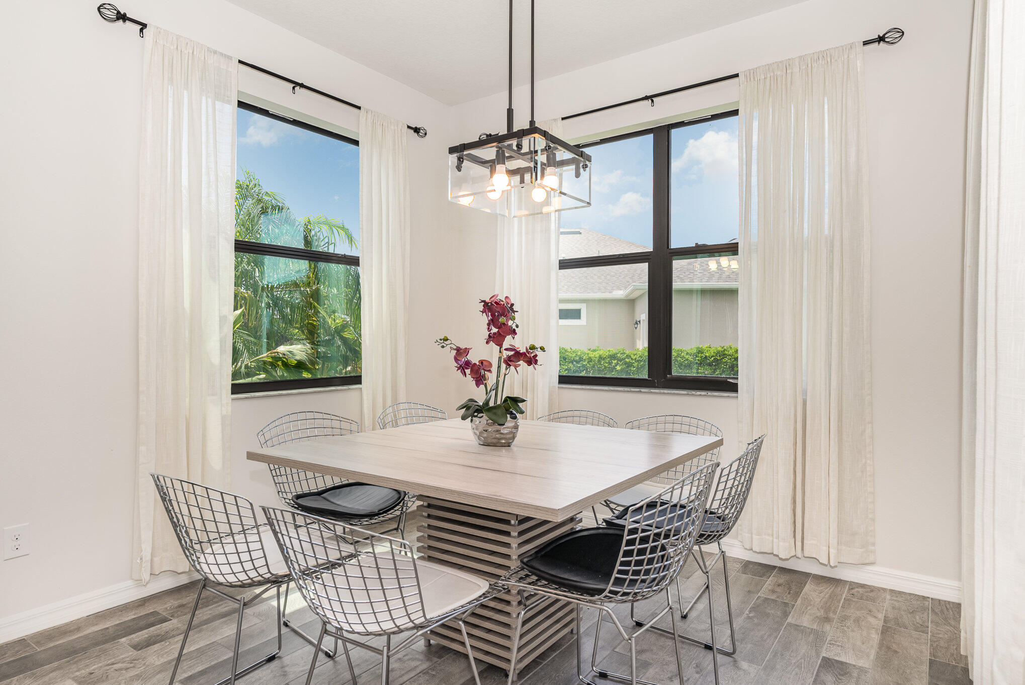 3179 Ribbon Grass Drive Melbourne, FL 32940 - Photo 11 of 52 a view of a dining room with furniture a chandelier and wooden floor