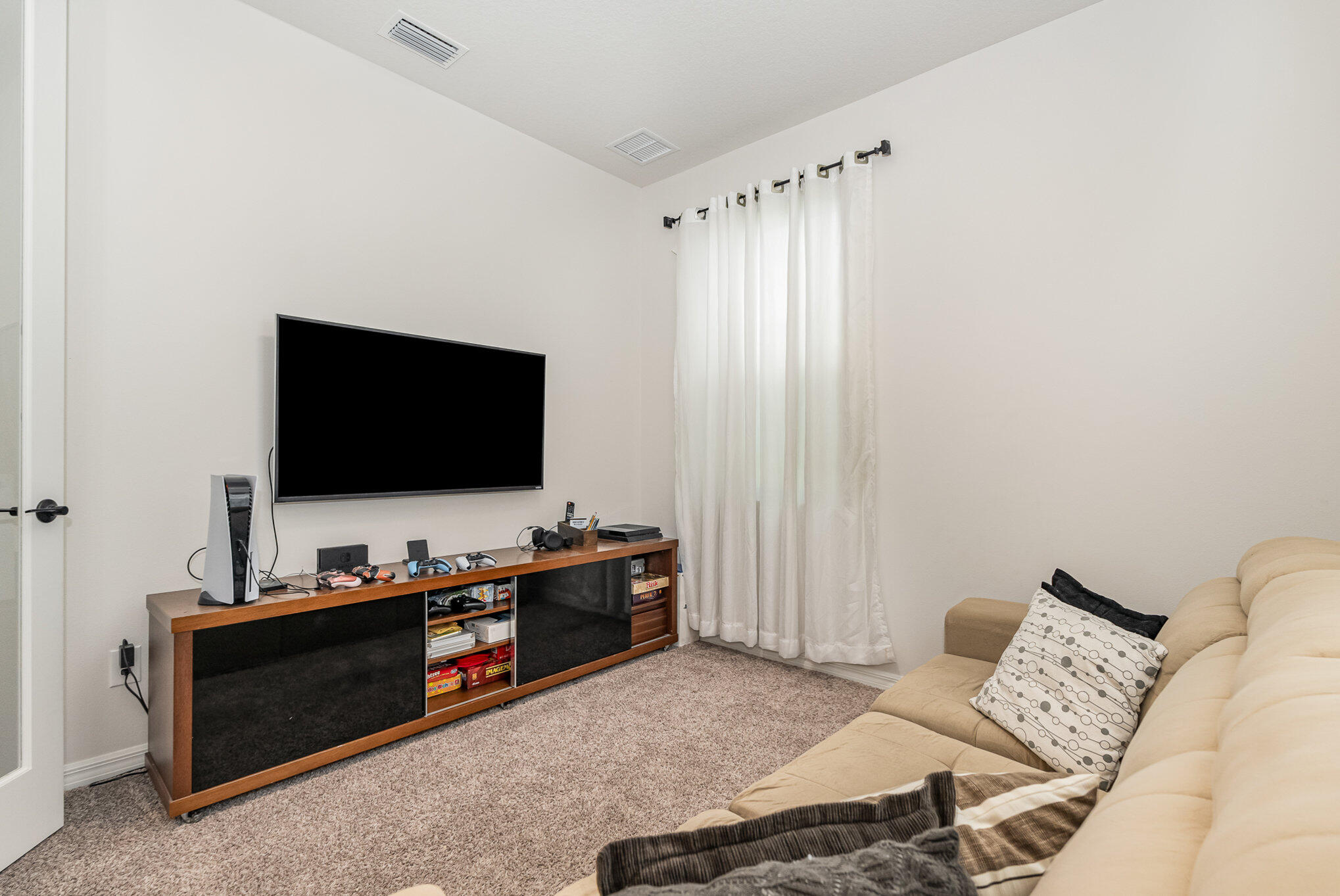 3179 Ribbon Grass Drive Melbourne, FL 32940 - Photo 17 of 52 a living room with furniture and a flat screen tv