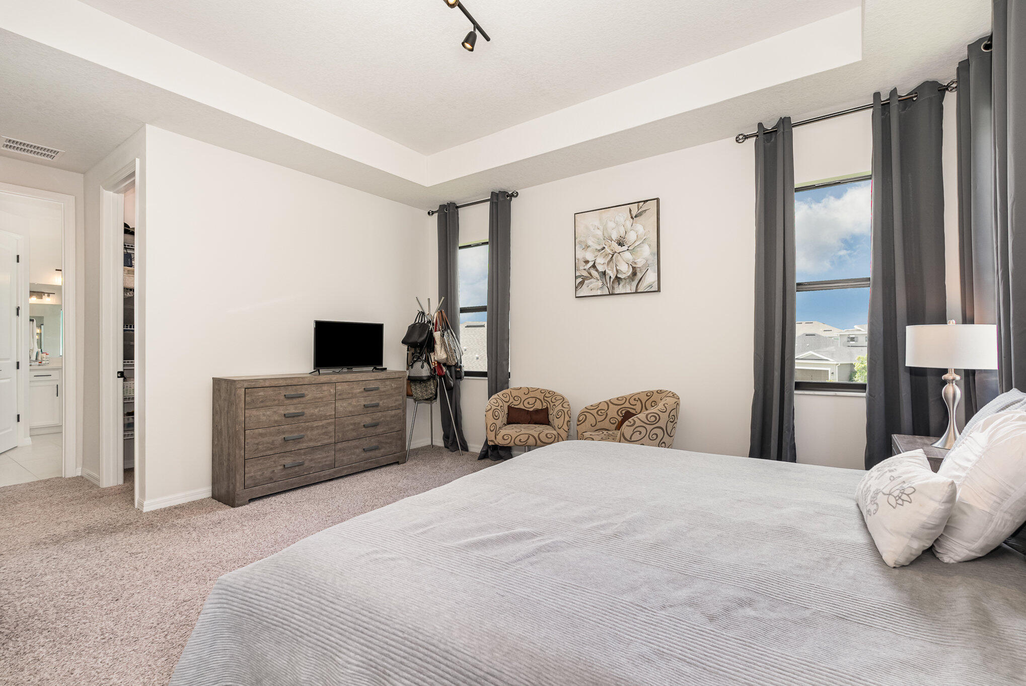 3179 Ribbon Grass Drive Melbourne, FL 32940 - Photo 21 of 52 a bedroom with a large bed and a flat screen tv