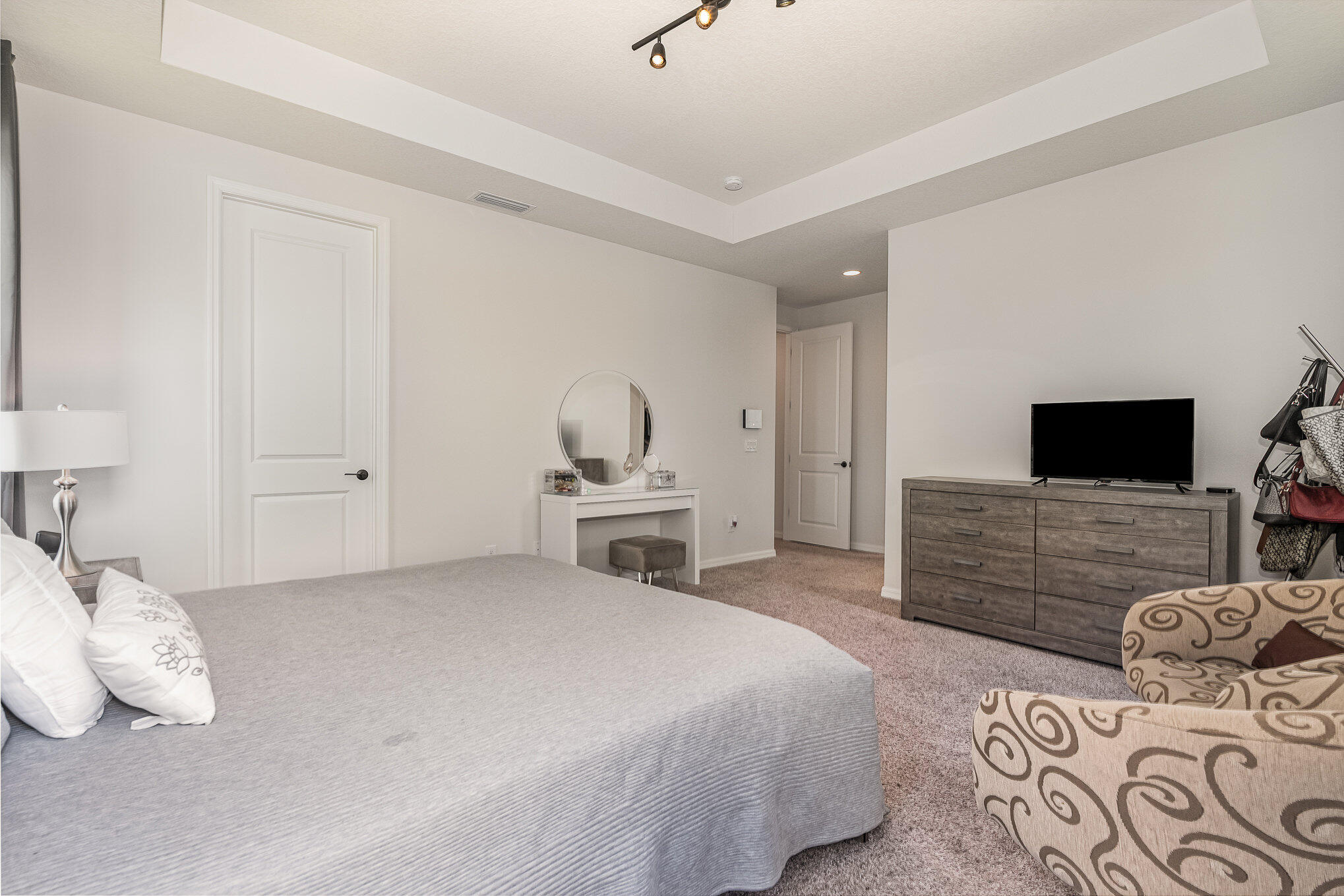 3179 Ribbon Grass Drive Melbourne, FL 32940 - Photo 22 of 52 a bedroom with a bed and flat screen tv