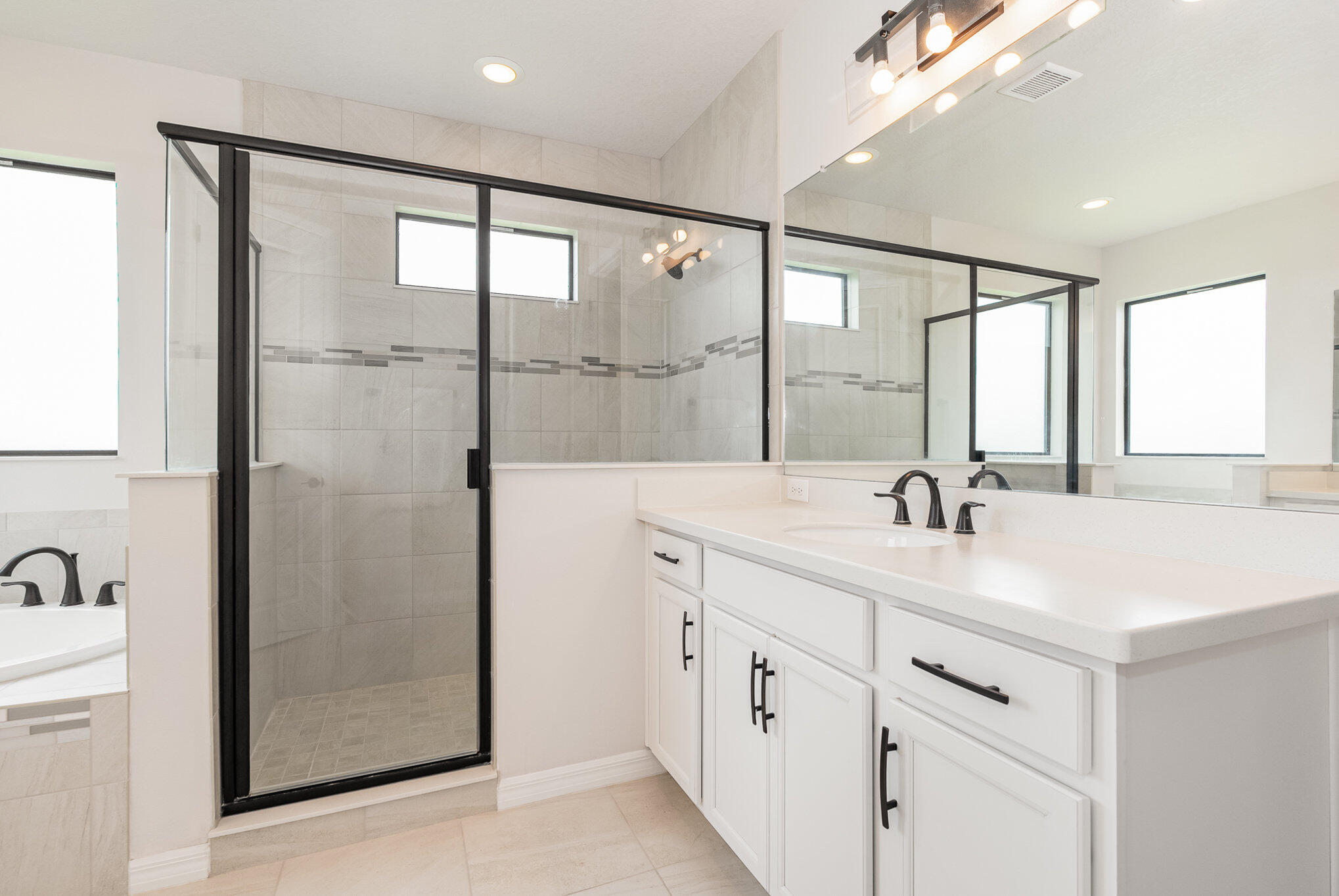 3179 Ribbon Grass Drive Melbourne, FL 32940 - Photo 24 of 52 a bathroom with a shower sink and mirror