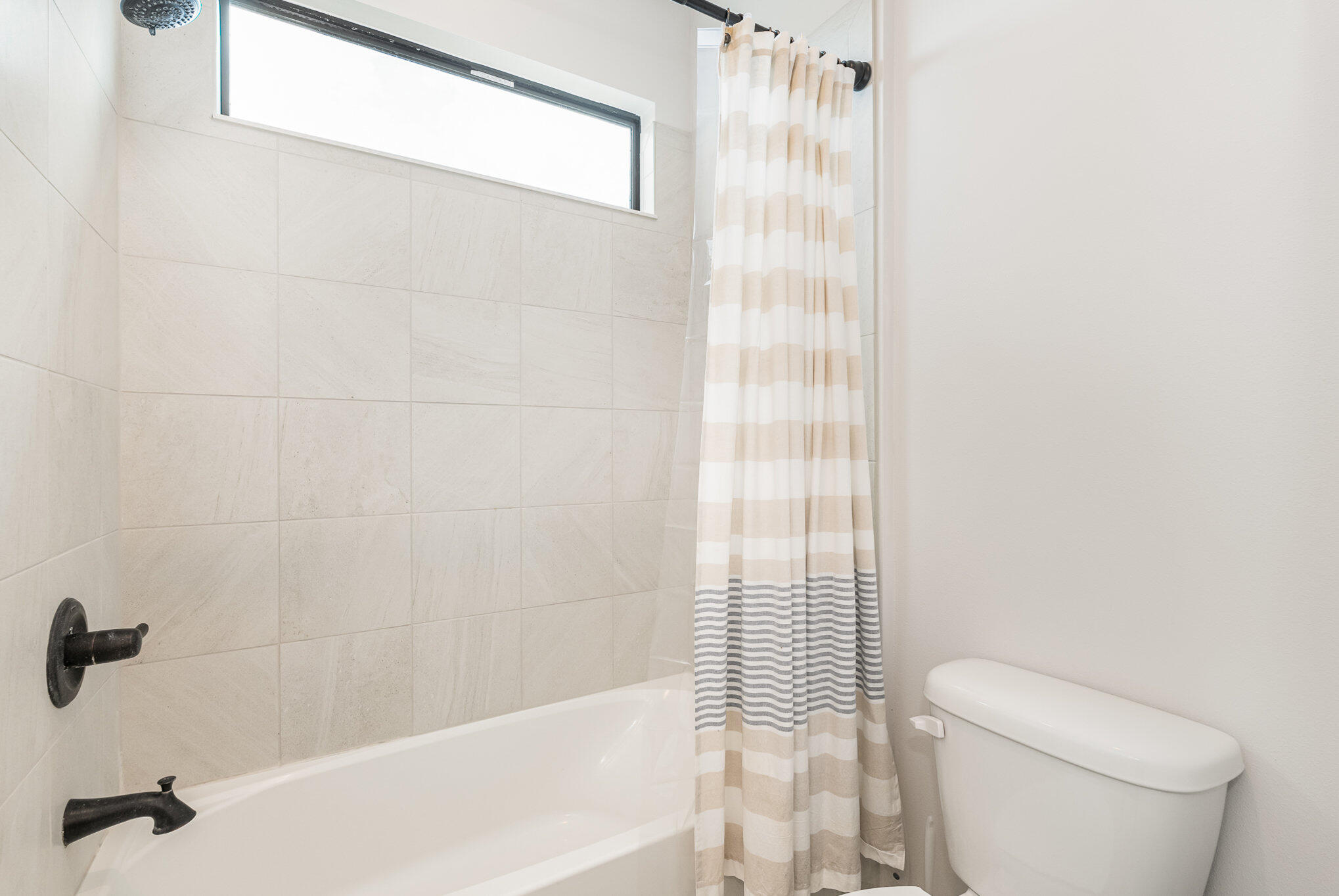 3179 Ribbon Grass Drive Melbourne, FL 32940 - Photo 32 of 52 a bathroom with a shower curtain