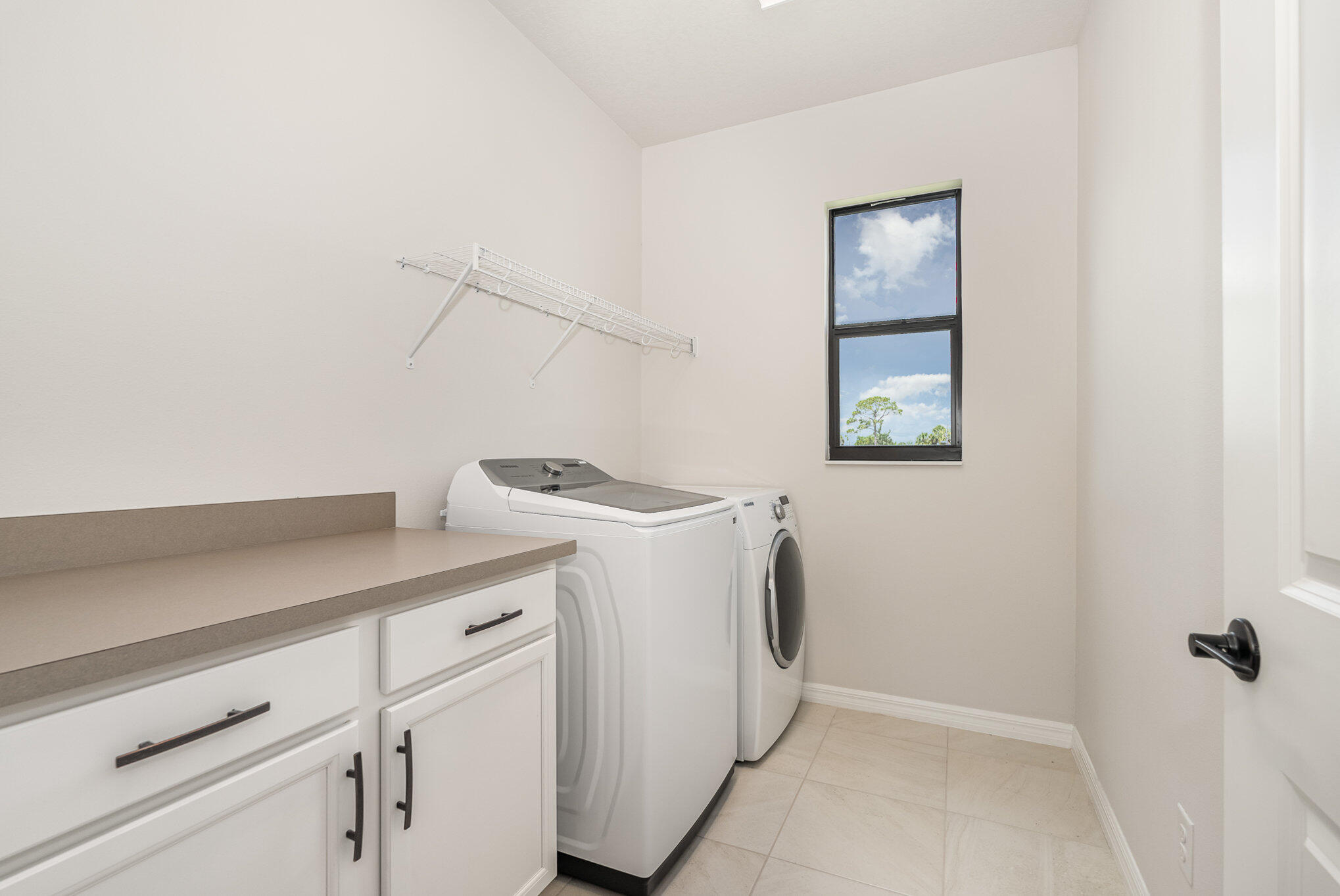3179 Ribbon Grass Drive Melbourne, FL 32940 - Photo 33 of 52 a utility room with dryer and washer