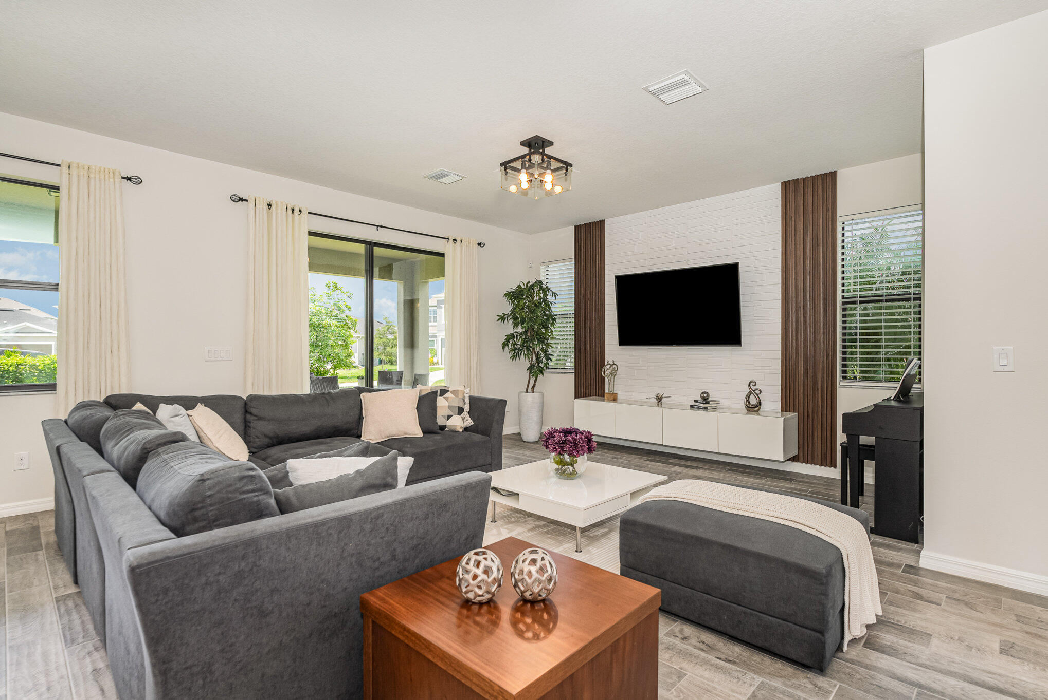 3179 Ribbon Grass Drive Melbourne, FL 32940 - Photo 4 of 52 a living room with furniture and a flat screen tv