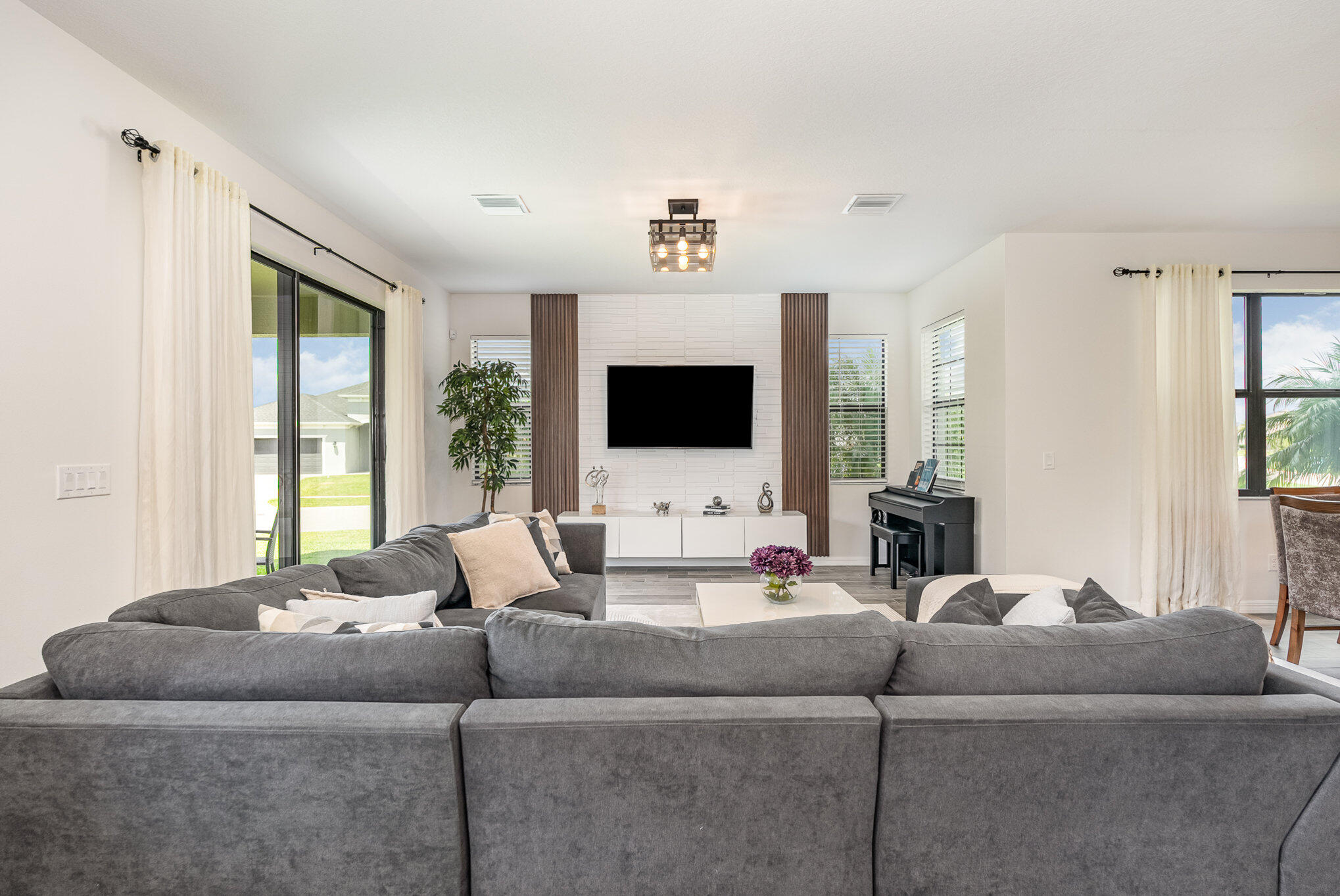3179 Ribbon Grass Drive Melbourne, FL 32940 - Photo 6 of 52 a living room with furniture and a flat screen tv