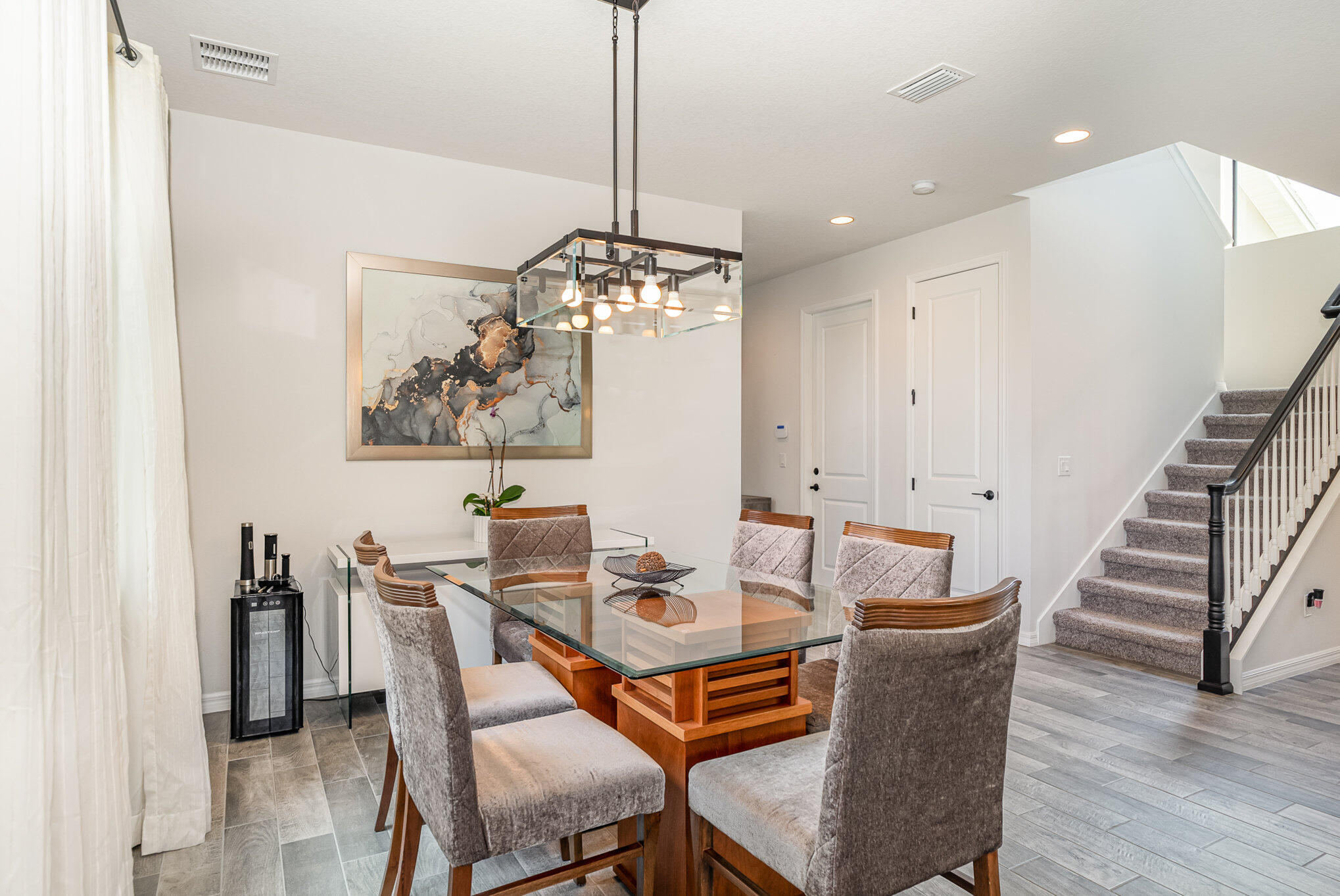 3179 Ribbon Grass Drive Melbourne, FL 32940 - Photo 10 of 52 a dining room with furniture and wooden floor