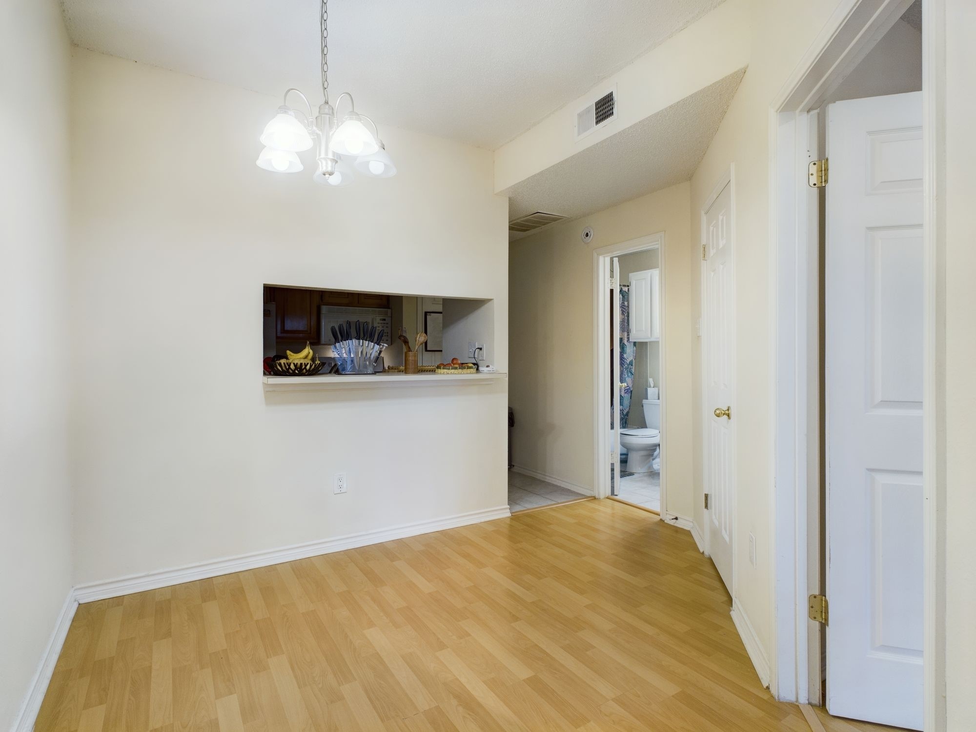 3001 Cedar Street, Unit 209 Austin, TX 78705 - Photo 5 of 17 a bedroom with a bed and a chandelier