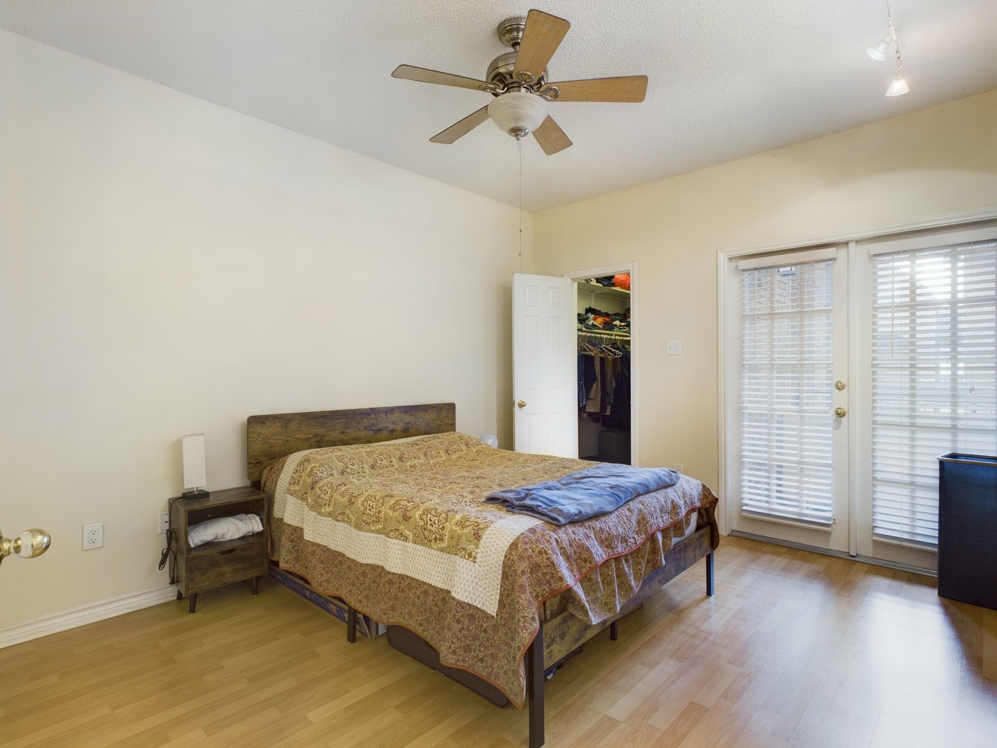 3001 Cedar Street, Unit 209 Austin, TX 78705 - Photo 6 of 17 a bedroom with a bed and a ceiling fan