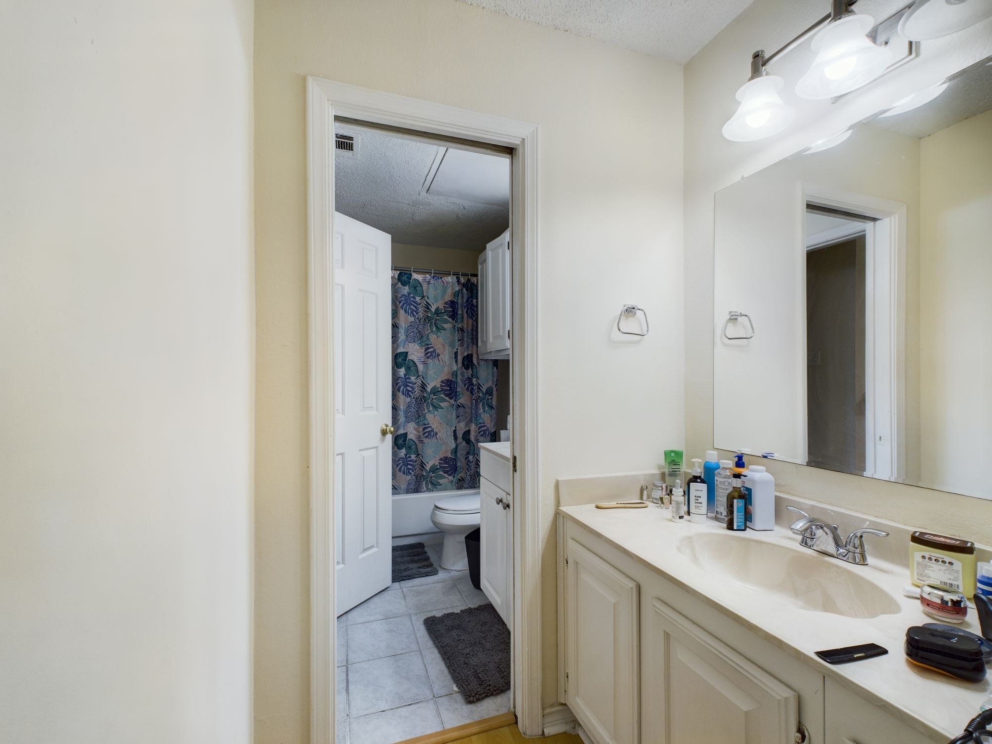 3001 Cedar Street, Unit 209 Austin, TX 78705 - Photo 8 of 17 a bathroom with a sink and mirror with toilet