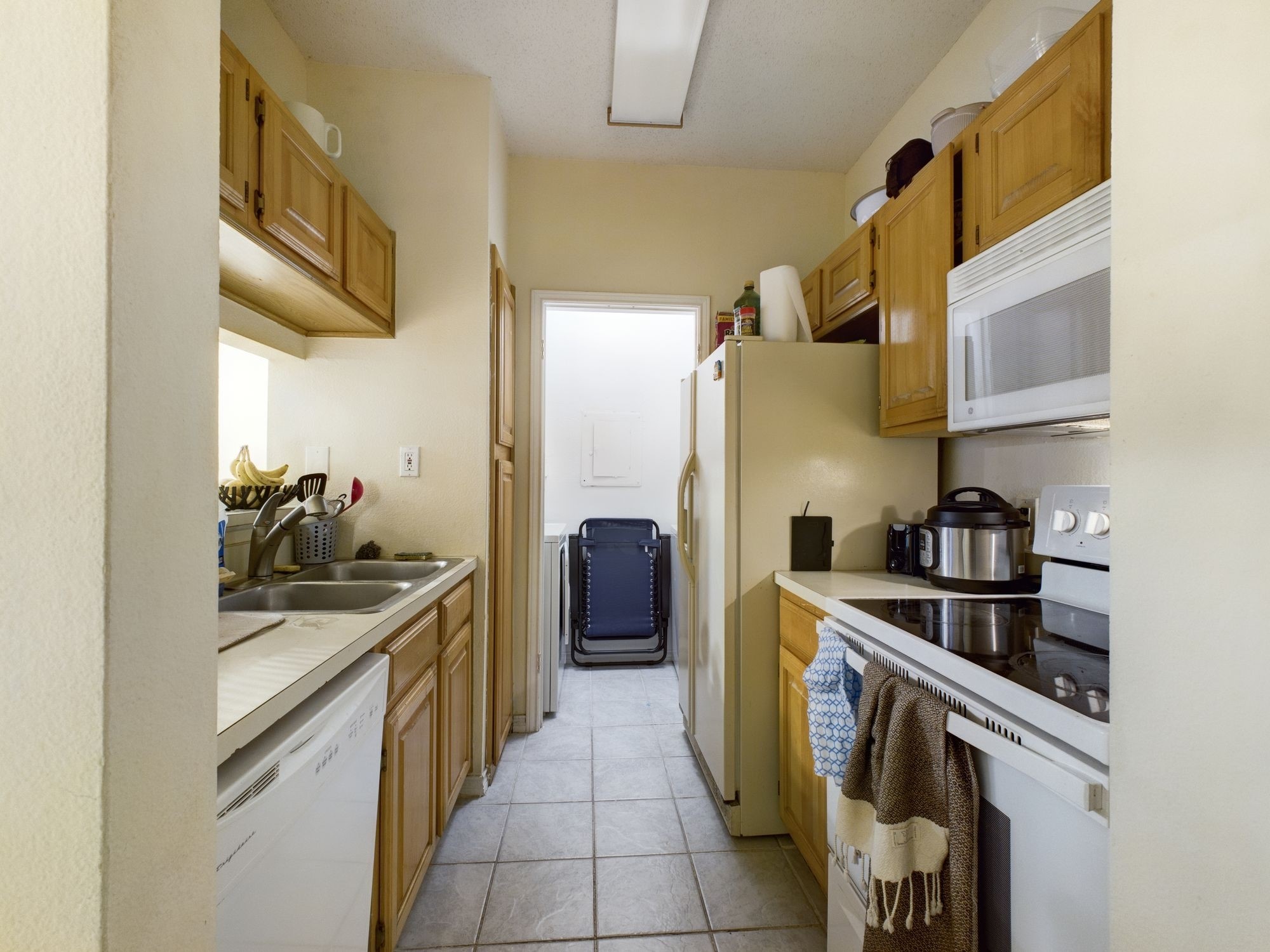 3001 Cedar Street, Unit 209 Austin, TX 78705 - Photo 10 of 17 a kitchen with stainless steel appliances granite countertop a sink and cabinets