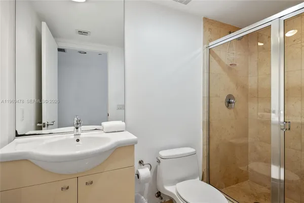 a bathroom with a sink toilet and shower