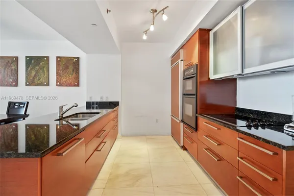 a kitchen with stainless steel appliances granite countertop a stove and a sink