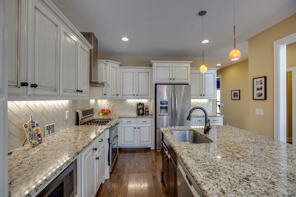 4065 Clovercroft Road Franklin, TN 37067 - Photo 14 of 30 a kitchen with kitchen island granite countertop a sink stainless steel appliances and cabinets