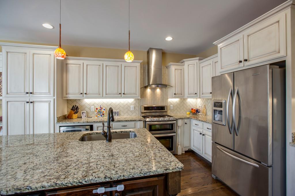 4065 Clovercroft Road Franklin, TN 37067 - Photo 15 of 30 a kitchen with stainless steel appliances granite countertop a sink refrigerator and cabinets