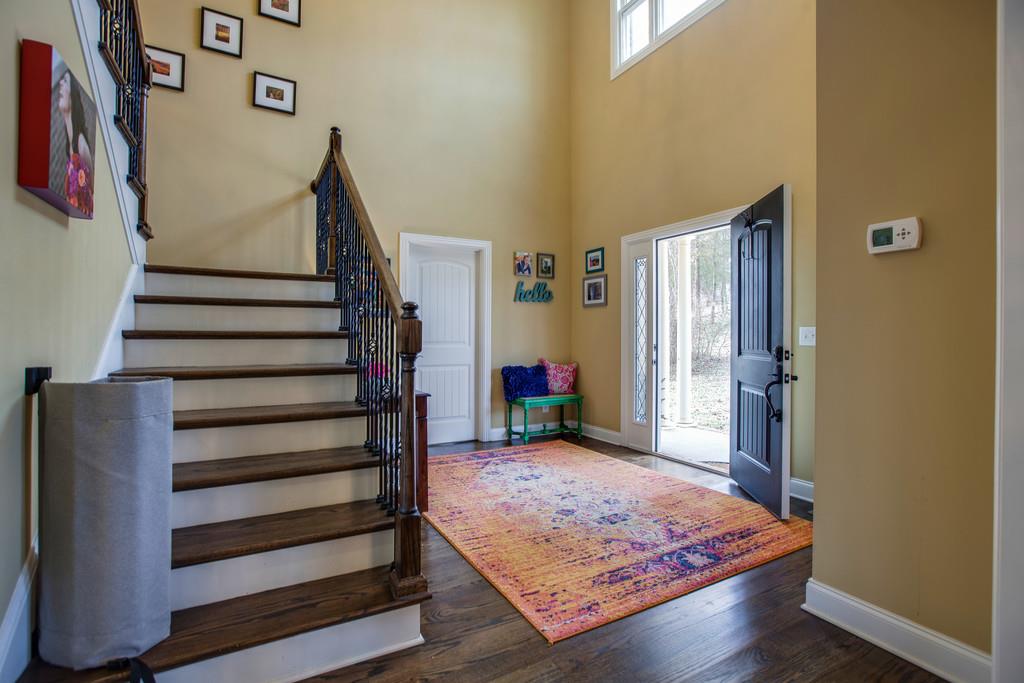 4065 Clovercroft Road Franklin, TN 37067 - Photo 2 of 30 a view of a hallway with wooden floor and stairs