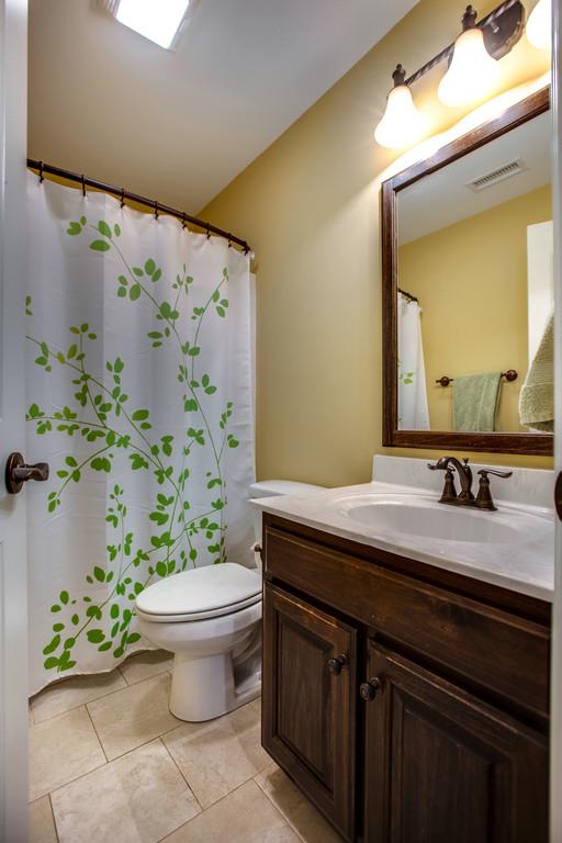 4065 Clovercroft Road Franklin, TN 37067 - Photo 26 of 30 a bathroom with a granite countertop toilet a sink and a mirror