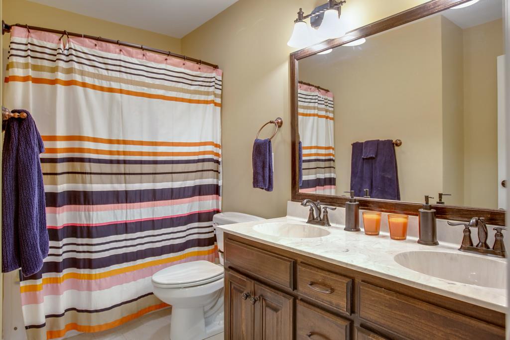 4065 Clovercroft Road Franklin, TN 37067 - Photo 27 of 30 a bathroom with a sink a toilet and a mirror