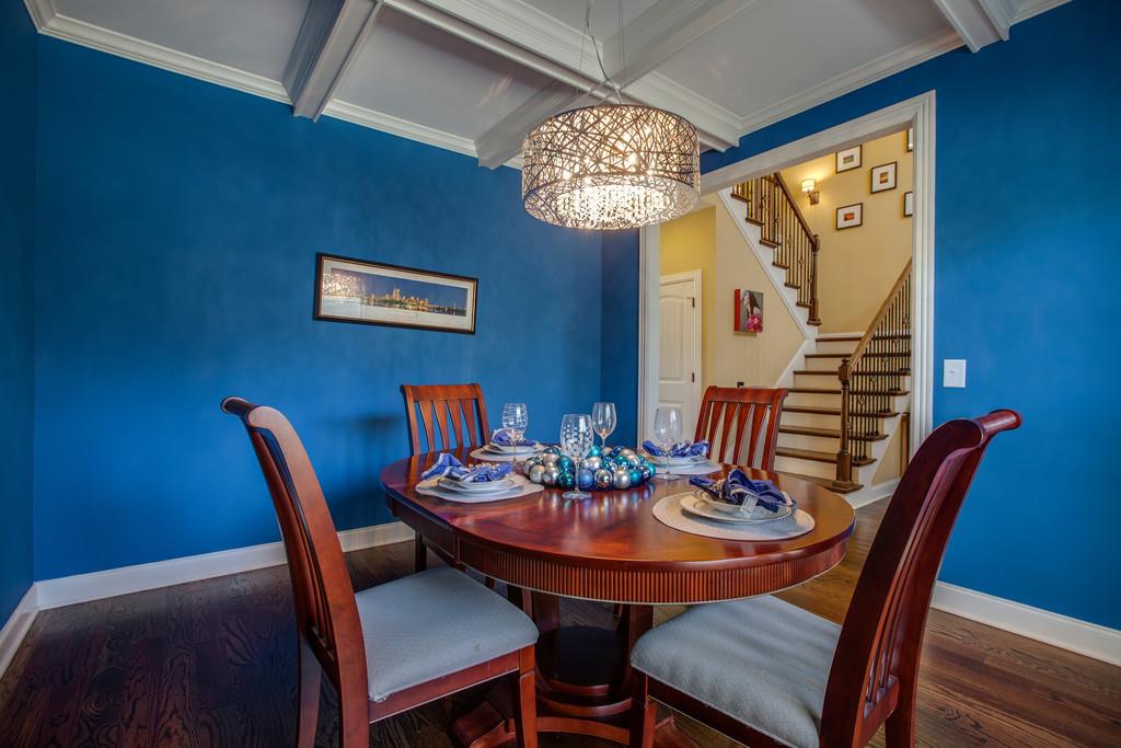4065 Clovercroft Road Franklin, TN 37067 - Photo 10 of 30 a view of a dining room with furniture a chandelier and wooden floor