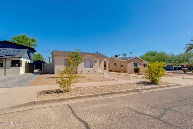 a front view of a house with a yard and sitting area