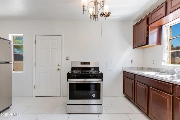 a kitchen with stainless steel appliances granite countertop a stove and a refrigerator
